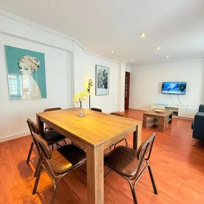 a dining room with a wooden table and chairs at Travel Habitat Mestalla in Valencia