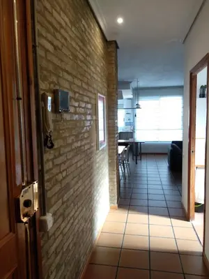 a hallway of a room with a brick wall at Apartamento con estilo in Valencia
