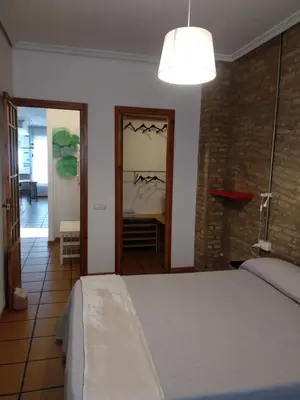 a bedroom with a bed and a door to a room at Apartamento con estilo in Valencia