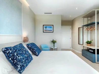 a bedroom with a large white bed with blue pillows at Opera House Valencia B&B in Valencia