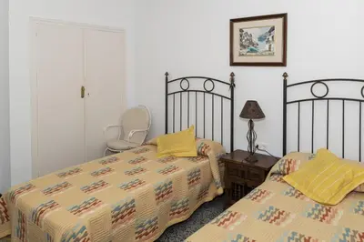a bedroom with two beds and a table with a lamp at Estrella, 2º-10 in Cullera