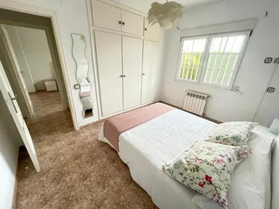 a bedroom with a bed and a large mirror at Casa Maica in Lliria