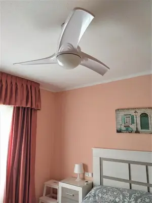 a ceiling fan in a bedroom with a bed at Mari Carmen, 2º-8 in Cullera