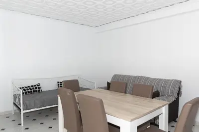a dining room with a table and chairs and a couch at La Ponderosa, 4º-21 in Cullera