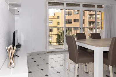a dining room with a table and chairs and a window at La Ponderosa, 4º-21 in Cullera