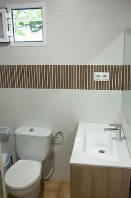a bathroom with a toilet and a sink at Camping Barraquetes in Sueca