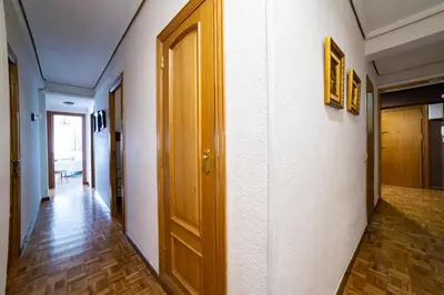 a hallway with a wooden door and a wooden floor at Awesome apartment center Valencia in Valencia