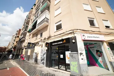 a building on a city street with a store at Awesome apartment center Valencia in Valencia