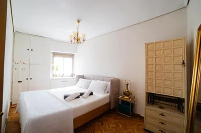 a bedroom with a white bed and a chandelier at Awesome apartment center Valencia in Valencia