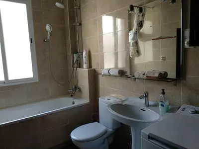 a bathroom with a white toilet and a sink at Burriana in Burriana
