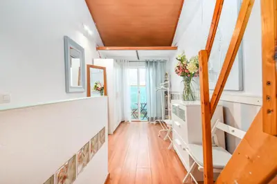 a room with white walls and wooden ceilings at La casita azul de la playa in Valencia