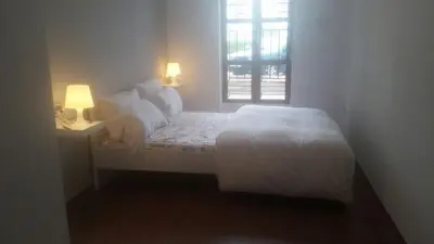 a white bedroom with a bed and a window at Malvarrosa Calle Pavia in Valencia