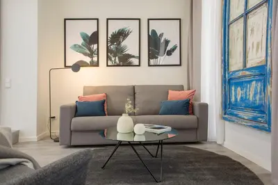 a living room with a couch and a table at Buenos Aires Apartments in Valencia
