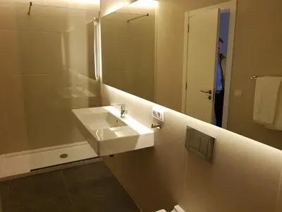 a bathroom with a white sink and a mirror at BONNIES Suites & Spa Valencia in Valencia