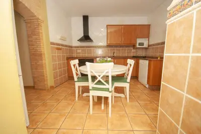a kitchen with a table and chairs in it at Casa La Posada de Chella in Chella
