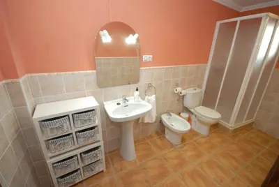 a bathroom with a sink and a toilet and a mirror at Casa La Posada de Chella in Chella