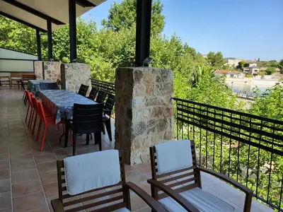 a patio with a table and chairs on a balcony at Balcón de las Fuentes in Navarrés