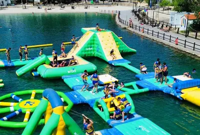 a group of people playing in a water park at Balcón de las Fuentes in Navarrés