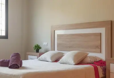 a bedroom with a large bed with two pillows at Balcón de las Fuentes in Navarrés