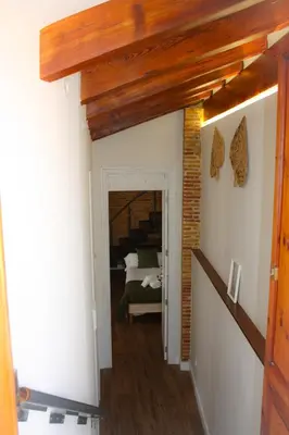 a hallway leading to a bedroom with a bed at Casa del Patriarca in Valencia