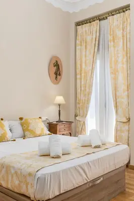 a bedroom with a large bed with a window at My Loft 4 You Gran Via in Valencia