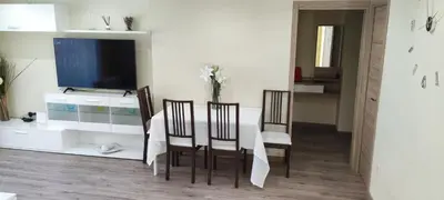 a living room with a table with chairs and a tv at CasaMalva in Valencia