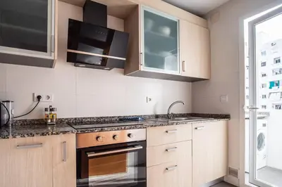 a kitchen with a sink and a stove top oven at Flats Burjasot in Valencia