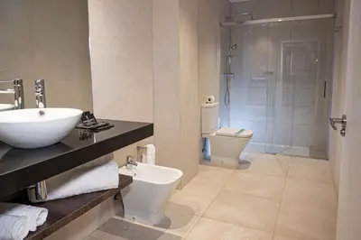 a bathroom with a sink and a toilet and a shower at Hotel Luve in San Antonio de Banageber