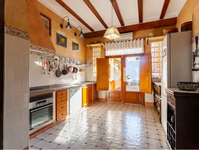 a kitchen with white appliances and a tile floor at La Isla del Júcar in Barraca de Aguas Vivas