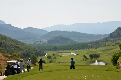 a group of people playing golf on a golf course at La Isla del Júcar in Barraca de Aguas Vivas