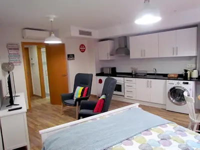 a room with a bed and chairs and a kitchen at Your Home at Valencia, El Carme in Valencia