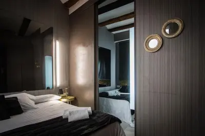 a hotel room with a bed and a mirror at Cosy Rooms Embajador in Valencia