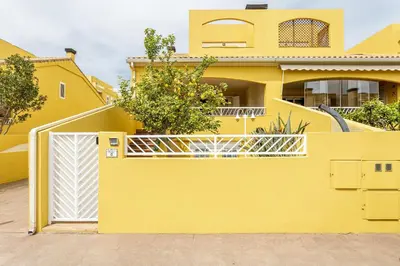 a yellow house with a white gate at Family-Friendly Beach House ideal for Holidays & Workers at Beach Sagunto Valencia in Sagunto