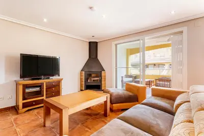 a living room with a couch and a flat screen tv at Family-Friendly Beach House ideal for Holidays & Workers at Beach Sagunto Valencia in Sagunto
