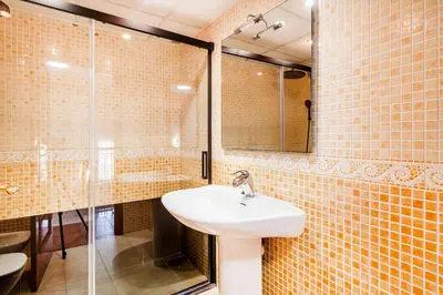 a bathroom with a sink and a glass shower at Family-Friendly Beach House ideal for Holidays & Workers at Beach Sagunto Valencia in Sagunto