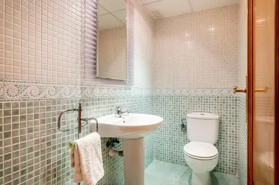 a bathroom with a white toilet and a sink at Family-Friendly Beach House ideal for Holidays & Workers at Beach Sagunto Valencia in Sagunto
