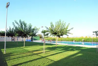 a park with a swimming pool with trees in the grass at Family-Friendly Beach House ideal for Holidays & Workers at Beach Sagunto Valencia in Sagunto