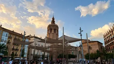 a building with a clock tower in a city at Cosy Rooms Bolsería in Valencia