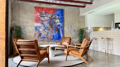 a room with chairs and a table and a painting at Cosy Rooms Bolsería in Valencia