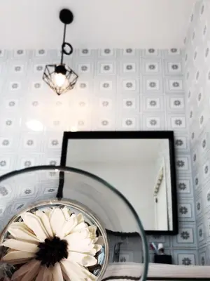a mirror with a flower in front of it at Harbor Apartments Valencia in Valencia