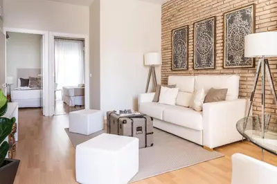 a living room with a white couch and a brick wall at MD Puerto Rico in Valencia