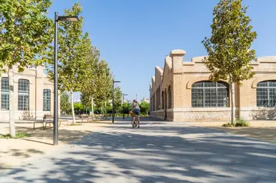 a person riding a bike in front of a building at MD Puerto Rico in Valencia
