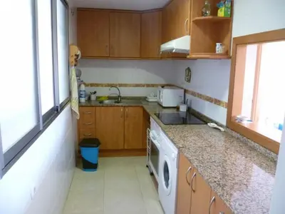 a kitchen with a sink and a washing machine at Hetesa 2000, 3º-7 in Cullera