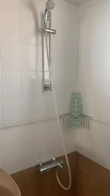 a shower with a hose in a bathroom at EL RACO- C, 8-16 in Cullera