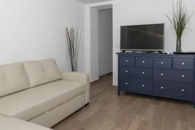 a living room with a couch and a tv on a dresser at Europa A- 12º-23 in Cullera