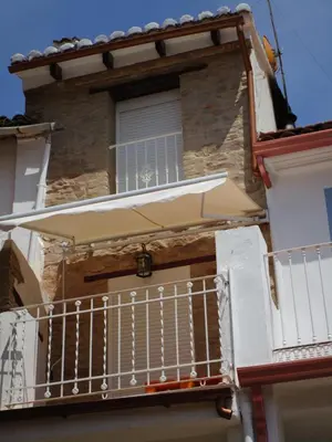 a balcony of a building with an umbrella at Ca'ls avis in Serra