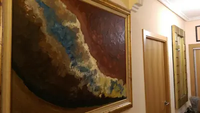 a large painting hanging on a wall in a hallway at Apartamento San Antonio in Sedaví