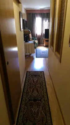 a hallway with a rug on the floor next to a door at Apartamento San Antonio in Sedaví