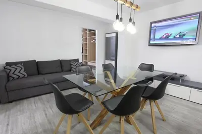 a living room with a glass table and black chairs at 5 SENSES in Valencia