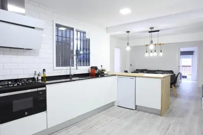a white kitchen with a sink and a stove at 5 SENSES in Valencia